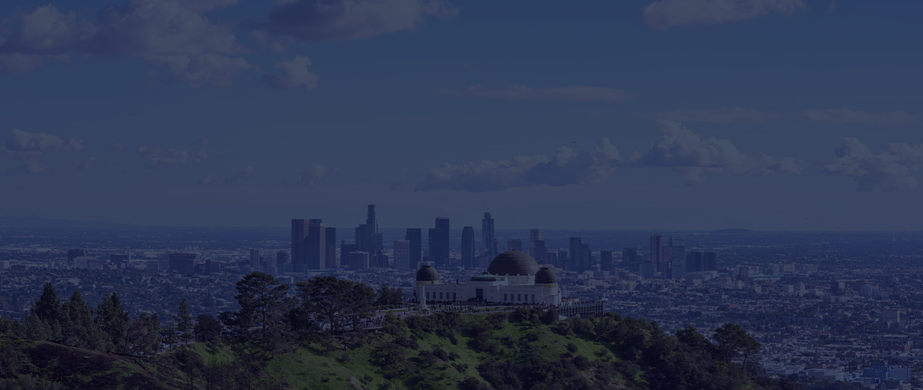 View of the Griffith Observatory with the Los Angeles skyline in the distance on a clear day.